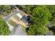 Aerial perspective of a modern home surrounded by dense trees, with a driveway leading to the property at 5022 Mockingbird Ln, Sanford, NC 27332