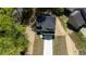 Birds-eye view of a modern two-story home featuring a driveway and surrounded by lush greenery in a quiet neighborhood at 5022 Mockingbird Ln, Sanford, NC 27332