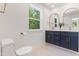 Modern bathroom with double vanity, gold fixtures and a large window at 5022 Mockingbird Ln, Sanford, NC 27332