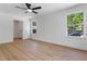 Bright bedroom features modern ceiling fan, neutral paint, and luxury vinyl flooring at 5022 Mockingbird Ln, Sanford, NC 27332