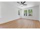 Bright bedroom with neutral paint, modern fan and large windows showing wooded view at 5022 Mockingbird Ln, Sanford, NC 27332
