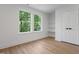 Bright bedroom with natural light from two windows, complemented by custom shelves and a closet at 5022 Mockingbird Ln, Sanford, NC 27332