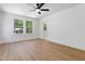 Bright bedroom features neutral paint, modern ceiling fan and ensuite bathroom entrance at 5022 Mockingbird Ln, Sanford, NC 27332
