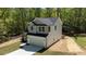 View of a two-story home with gray siding and a two car garage surrounded by new landscaping at 5022 Mockingbird Ln, Sanford, NC 27332