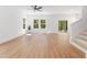 Living room with hardwood floors, modern lighting, and access to the backyard at 5022 Mockingbird Ln, Sanford, NC 27332