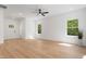 Living room with hardwood floors, white walls, and a view of the outdoors from the picture windows at 5022 Mockingbird Ln, Sanford, NC 27332