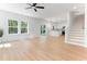 Spacious living room with hardwood floors, modern ceiling fan, and large windows at 5022 Mockingbird Ln, Sanford, NC 27332