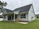 Rear exterior view showcases a well-maintained home, covered patio, and spacious backyard at 520 S Lincoln St, Benson, NC 27504