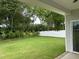 Serene backyard view with lush green grass and privacy fence, as seen from the covered porch at 520 S Lincoln St, Benson, NC 27504