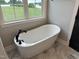 Beautiful bathroom featuring a luxurious stand alone tub and matte black fixtures, perfect for relaxing at 520 S Lincoln St, Benson, NC 27504