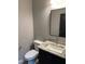 This bathroom features a modern sink with granite countertops and ample lighting at 520 S Lincoln St, Benson, NC 27504