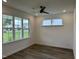 Bright bedroom with hardwood floors, a ceiling fan, and large windows offering scenic views at 520 S Lincoln St, Benson, NC 27504