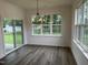 Dining area with chandelier, natural light, sliding glass door, and wood floors at 520 S Lincoln St, Benson, NC 27504