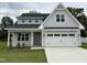 Inviting two-story home boasts gray siding, a two-car garage, and a meticulously maintained front lawn at 520 S Lincoln St, Benson, NC 27504