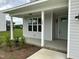 Welcoming front porch features classic columns, a stylish front door, and manicured landscaping at 520 S Lincoln St, Benson, NC 27504