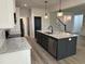 Kitchen view with an island with sink, granite countertops, stainless appliances and bar stool seating at 520 S Lincoln St, Benson, NC 27504
