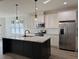 Kitchen with stainless steel appliances, large island with seating, and pendant lighting at 520 S Lincoln St, Benson, NC 27504