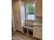 Bright kitchen nook with a built-in bench and storage cabinets, perfect for enjoying the view at 520 S Lincoln St, Benson, NC 27504