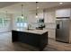 Modern kitchen with a large island, granite countertops, stainless steel appliances, and stylish lighting at 520 S Lincoln St, Benson, NC 27504