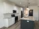 Open concept kitchen with white cabinets, stainless appliances, granite countertops and large island at 520 S Lincoln St, Benson, NC 27504