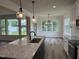 Well-designed kitchen featuring a central island with granite countertops, stainless appliances, and ample natural light at 520 S Lincoln St, Benson, NC 27504