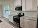 Beautiful kitchen featuring stainless appliances, granite countertops, white cabinets and a window at 520 S Lincoln St, Benson, NC 27504