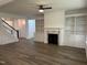 Open-concept living room features hardwood floors, built-in shelving, and a cozy fireplace at 520 S Lincoln St, Benson, NC 27504