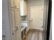 Mud room with storage cabinet, bench, and entry door to the home at 520 S Lincoln St, Benson, NC 27504