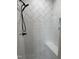 Modern shower features white subway tile, mosaic floor, sleek black fixtures, and a built-in bench at 520 S Lincoln St, Benson, NC 27504