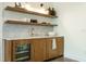 Elegant bar area with sleek cabinetry, marble backsplash, and wine fridge at 5265 Aleppo Ln, Raleigh, NC 27613