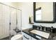 Modern bathroom with sleek subway tile shower, granite countertop, and unique decor mirror at 5265 Aleppo Ln, Raleigh, NC 27613