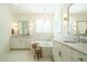 Bright bathroom with marble countertops, a chandelier, soaking tub, and white shaker cabinets at 5265 Aleppo Ln, Raleigh, NC 27613