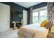 Dark-walled bedroom features large window with patterned curtains, and a beautifully made bed with decorative pillows at 5265 Aleppo Ln, Raleigh, NC 27613