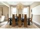 Elegant dining room with a modern chandelier, stylish chairs, and large windows for natural light at 5265 Aleppo Ln, Raleigh, NC 27613