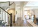 Inviting entryway with hardwood floors, staircase and a glimpse into a cozy living space at 5265 Aleppo Ln, Raleigh, NC 27613