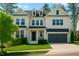 Charming two-story home boasts a well-manicured lawn and an attached two-car garage at 5265 Aleppo Ln, Raleigh, NC 27613