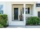 Elegant front entrance featuring a black door, white trim, and decorative shrubs for curb appeal at 5265 Aleppo Ln, Raleigh, NC 27613