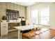 Stylish home office with modern desk, custom wallpaper, and ample natural light at 5265 Aleppo Ln, Raleigh, NC 27613