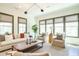 Bright and airy living room boasts modern design, comfortable seating, and large windows with scenic views at 5265 Aleppo Ln, Raleigh, NC 27613