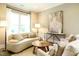 Bright living room with neutral tones, stylish furniture, and a large window for ample light at 5265 Aleppo Ln, Raleigh, NC 27613