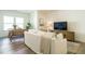 Open-concept living room with modern decor, a large sofa, and a view of the dining area at 5265 Aleppo Ln, Raleigh, NC 27613