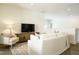 Bright living room with modern decor, a large sofa, hardwood floors, and a television at 5265 Aleppo Ln, Raleigh, NC 27613