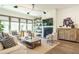 Bright, comfortable living room with fireplace, stylish furnishings, decor, and large windows at 5265 Aleppo Ln, Raleigh, NC 27613