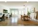 Open living space featuring desks, a dining area, large windows, and polished concrete floors at 5265 Aleppo Ln, Raleigh, NC 27613