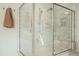 Glass enclosed shower with bench, dual shower heads and white subway tile at 5265 Aleppo Ln, Raleigh, NC 27613