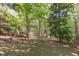 A serene and secluded backyard surrounded by lush greenery and mature trees at 5504 Spring Bluffs Ln, Raleigh, NC 27606