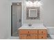 Well-lit bathroom with white countertops and wood cabinets at 5504 Spring Bluffs Ln, Raleigh, NC 27606