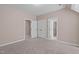Neutral bedroom featuring carpet, white trim, and multiple doors/entryways at 5504 Spring Bluffs Ln, Raleigh, NC 27606