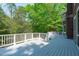 Large deck with white railings overlooking a lush, green backyard at 5504 Spring Bluffs Ln, Raleigh, NC 27606