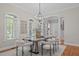 Elegant dining room with a marble table, stylish chairs, and ample natural light at 5504 Spring Bluffs Ln, Raleigh, NC 27606